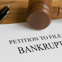 A gavel with a bankruptcy file