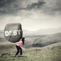 Businesswoman brings rock with Debt word