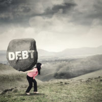 Businesswoman brings rock with Debt word Businesswoman brings rock with Debt word
