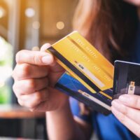 Closeup image of a woman holding and choosing credit card to use