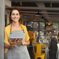 Small business owner at entrance looking at camera Small business owner at entrance looking at camera