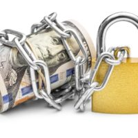 Dollar bills wrapped by chain and secured with padlock. Isolated on white. Safety money and investment concept.