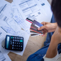 Business people are stressed about credit card debt and many bills on the floor. Men get trouble by calculating monthly expenses and then budgeting not enough money for paying debts. Business people are stressed about credit card debt and many bills on the floor. Men get trouble by calculating monthly expenses and then budgeting not enough money for paying debts.