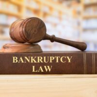 Bankruptcy Law books with a judges gavel on desk in the library. Concept of bankruptcy law,bankrupt,bankruptcy court,law education ,law books. Bankruptcy Law books with a judges gavel on desk in the library. Concept of bankruptcy law,bankrupt,bankruptcy court,law education ,law books.