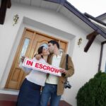 Portrait of a happy couple kissing outside new house